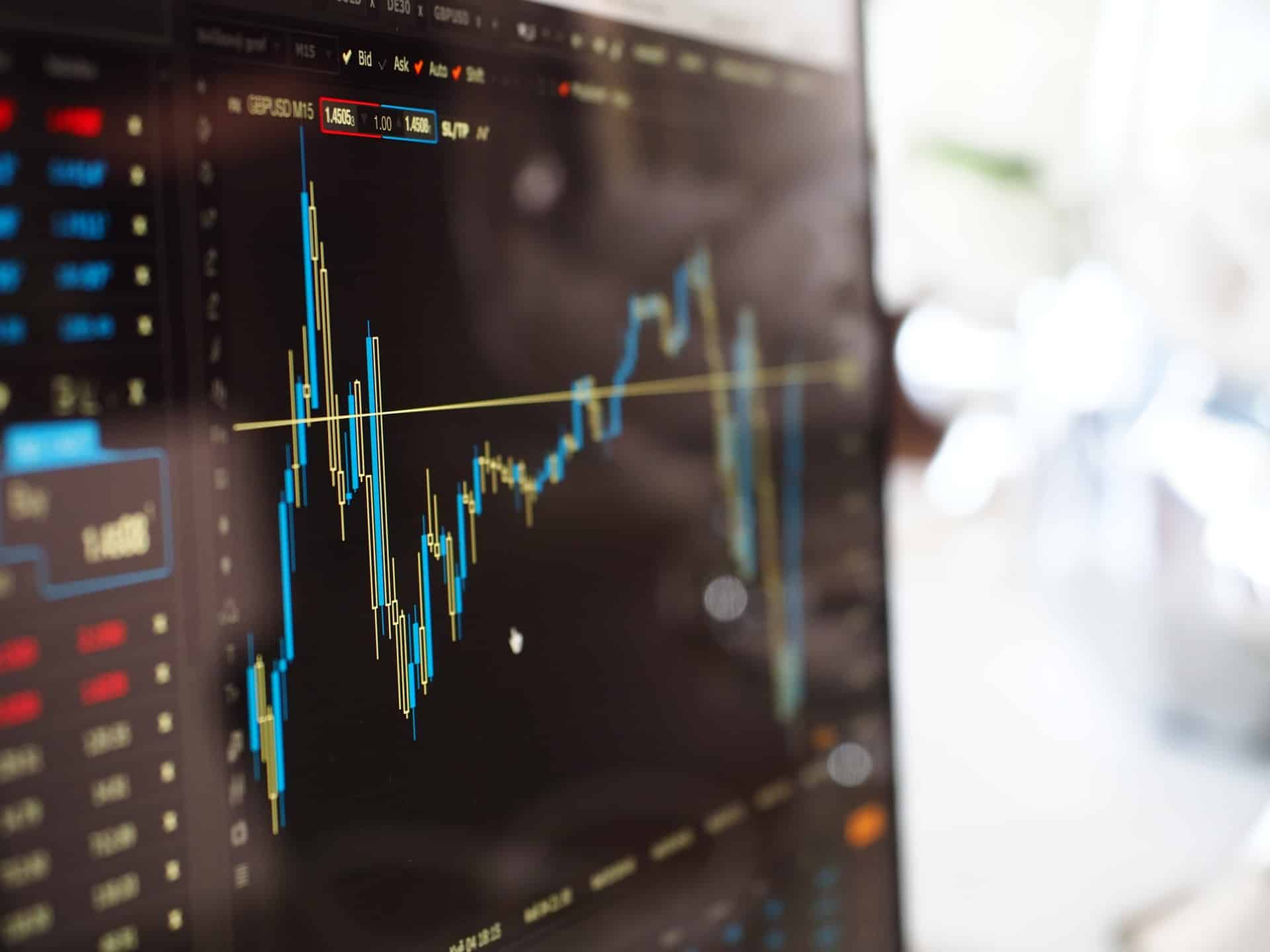 blue-and-yellow-graph-on-stock-market-monitor