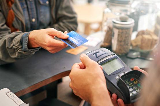 Someone purchasing something at a store using a credit card